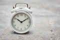 White vintage alarm clock on the gray background. Productivity control and task planning concept