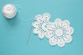 White vintage crochet doily. Cotton yarn for knitting, crochet hook