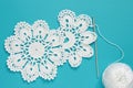 White vintage crochet doily. Cotton yarn for knitting, crochet hook