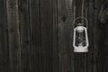 White vintage handle gas lantern on rustic wooden wall. Royalty Free Stock Photo