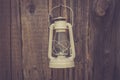 White vintage handle gas lantern on rustic wooden wall. Royalty Free Stock Photo