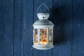 White vintage Lantern with burning candles, pine cones on wooden table and glitter lights background. Christmas background. happy Royalty Free Stock Photo