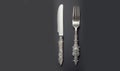 White vintage silver cutlery view from above on a grey background. Top view. Antique knife and fork for a festive table Royalty Free Stock Photo