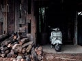 White vintage Vespa motor scooter parking in wood cabin