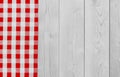 White vintage wooden table with red checker napkin. Checkered fabric and wooden light background. Decoration kitchen towel. Table Royalty Free Stock Photo