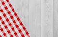 White vintage wooden table with red checker napkin. Checkered fabric and wooden light background. Decoration kitchen towel. Table Royalty Free Stock Photo