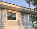 White vinyl pvc windows on textured wall of vintage country house.