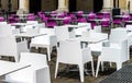 White and violet chairs and tables in cafe