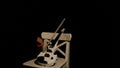 White violin on a white chair on a black background