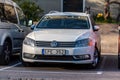 A white 2013 Volkswagen Passat at a parking lot..