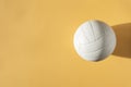 White volleyball leather ball on yellow background Royalty Free Stock Photo