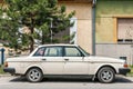 White Volvo 240 car model parked on the street old timer classical car