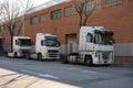 White Volvo FH12 and Renault Magnum 500 trucks parked on the street