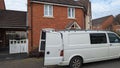 A white vw transporter removals van parked on the street doors open for a house removal service Royalty Free Stock Photo