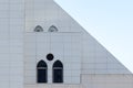 White wall with an arched and round windows, detail of building exterior, urban geometry Royalty Free Stock Photo