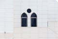 White wall with an arched and round windows, detail of building exterior, urban geometry Royalty Free Stock Photo