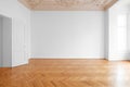 White wall background in empty apartment room , flat with wooden floor and stucco ceiling Royalty Free Stock Photo