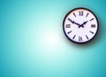 White wall clock on blue background.