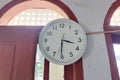 A white wall clock hangs on the wall Royalty Free Stock Photo