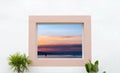 White Wall concrete texture with open window frame looking out to sea view with sunset s in the beach sand,Exterior White cement Royalty Free Stock Photo