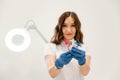 White wall. Cosmetologist holding syringes for injection lips augmentation. Women's cosmetology in the beauty salon