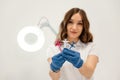 White wall. Cosmetologist holding syringes for injection lips augmentation. Women's cosmetology in the beauty salon