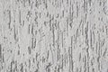 White wall with decorative trim. Texture of the putty for external finishing. Decorative scratches on the surface. Royalty Free Stock Photo
