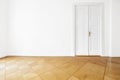 White wall door in renovated apartment room with parquet floor Royalty Free Stock Photo