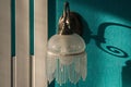 White wall sconces hanging on a turquoise wall. Royalty Free Stock Photo