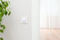 White wall switch on the wall. Light interior Royalty Free Stock Photo