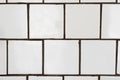 White wall tile pattern for decoration. Close-up vintage bathroom ceramic square tiles with defects