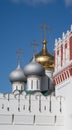 White wall and watchtower of Novodevichy Convent against the background of the domes of the cathedral, Moscow, 2021 Royalty Free Stock Photo
