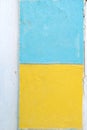 White wall with yellow and blue paint squares Royalty Free Stock Photo