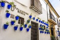 White walls and blue flower pots at Calle Velazquez Bosco near Calleja de las Flores