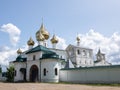 White walls, green roof and gold domes of the monastery