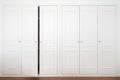 White wardrobe in american classic style with ajar door Royalty Free Stock Photo