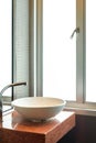 White wash basin with steel faucet in empty bathroom Royalty Free Stock Photo