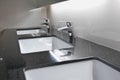 White washbasins and faucet on granite counter Royalty Free Stock Photo