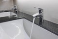 White washbasins and faucet on granite counter Royalty Free Stock Photo