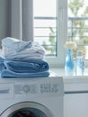 A white washing machine with a stack of neatly folded laundry on top. Generative AI Royalty Free Stock Photo