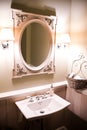 White washstand with large oval mirror