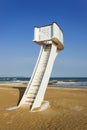 Watchtower on an empty beach with blue sky