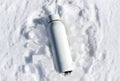 White water bottle surrounded by ice cubes in fresh snow Royalty Free Stock Photo