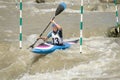 White water kayak athlete racing through a downstream slalom gate Royalty Free Stock Photo