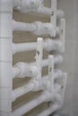 White water pipes on the wall in the house. Decoupling of water pipes with valves on the wall in the boiler room. Many Royalty Free Stock Photo