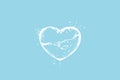 White water splash heart shape on a light blue background Royalty Free Stock Photo