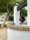 White water well with old pulley and bucket Royalty Free Stock Photo