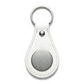 White waterdrop-shaped leather keychain with silver metal plate and keyring isolated on white background Royalty Free Stock Photo