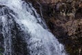 white waterfall frozen in place as it crashes down from dark stones Royalty Free Stock Photo