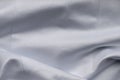 White wave satin fabric. Bridal wedding dress textile background